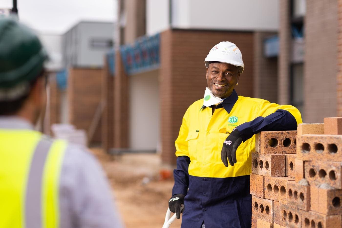 Worker standing near bricks